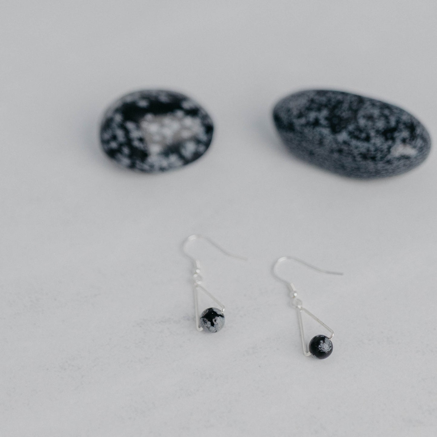 Handgefertigte Montara Ohrringe in Dreiecksform – inspiriert von der Bergform. Dezenter, moderner Edelsteinschmuck mit Schneeflockenobsidian. Einzigartige Begleiter von Moonlight Edelsteine.